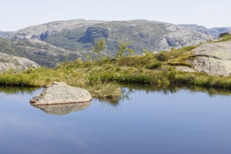 A mountain lake in the alpine tundra landscape of the Scandinavian Mountains near the Preikestolen
