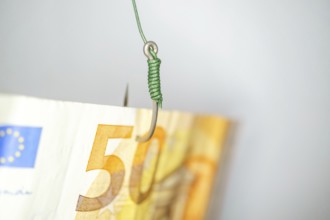 Euro banknote on a fishing hook creating a financial trap, symbolizing risk, temptation, and debt
