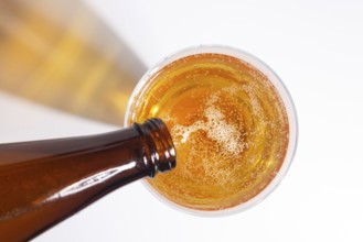 Beer pouring from a bottle into a glass