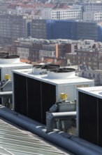 Air conditioning ventilators on roof with houses in background Prague Czech republic
