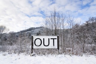 Out sign in snowy landscape, New Years Resolutions, self-improvement concept, lifestyle change,