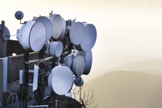 Transmitters and aerials on telecommunication tower during sunset Liberec Czech republic