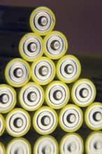 Yellow double A batteries reflecting in mirror, electricity storage concept