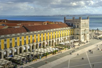 Scenic view of Commerce Square or Praca do Comercio in Lisbon, Portugal, iconic yellow Pombaline