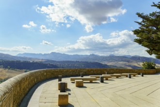Ronda, malaga, spain viewpoint terrace offers stone benches for relaxing while observing the scenic
