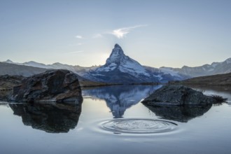 Matterhorn Mountain and Reflection in Lake Stellisee in Evening. Ripples in Circles. Swiss Alps.