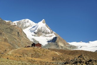 Snow-Capped Mountains and Mountain Hut on Sunny Day. Swiss Alps. Valais, Switzerland