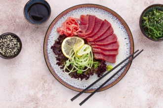Freshly prepared sashimi with vibrant garnishes served on a decorative plate