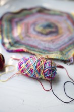 Crochet hooks, wool and crocheted blanket