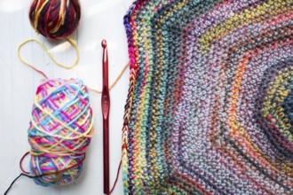 Crochet hooks, wool and crocheted blanket