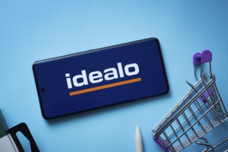 Dhaka, Bangladesh- 03 July 2025: Smartphone displaying idealo logo with shopping cart on a blue