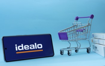 Dhaka, Bangladesh- 03 July 2025: Smartphone with idealo logo next to a small shopping cart and