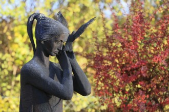 Statue of woman with dove on grave, cemetery, Lüdersen mountain village, city of Springe, Hanover