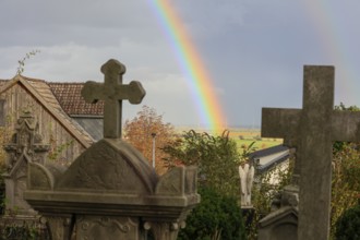 Rainbow over the heritage-protected cemetery near St. Marien Church, Lüdersen mountain village,