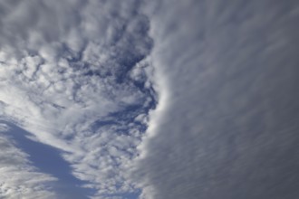A low-lying closed cloud cover divides the sky into two parts, Upper Bavaria, Bavaria, Germany
