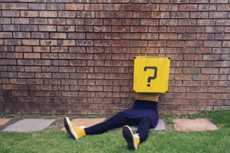 Body lying on a wall, question mark as head