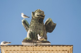 Sculpture of lion detail of San Marco coloumn on San Marco square, Venice, Italy
