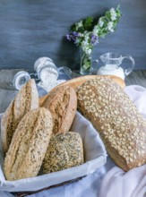 Freshly baked artisanal bread assortment displaying sourdough, multigrain, and seeded loaves and