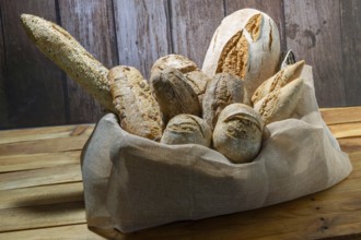 Freshly baked artisanal bread assortment including baguettes and rolls, creating a rustic still