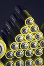 Yellow double A batteries reflecting in mirror, electricity storage concept