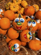 Painted pumpkins with faces in supermarket