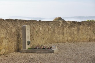 Lonely children's grave on a cemetery wall, fresh plants for All Saints Day, Upper Bavaria,