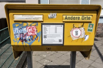 Painted and stickered post box in Mörsenbroich — Düsseldorf, North Rhine-Westphalia, Germany