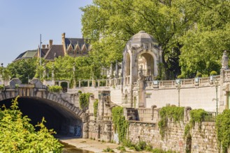 City park with large green wall, pagoda and underpass for the Vienna River, Vienna, Austria