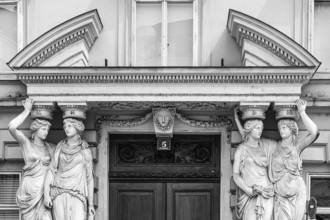 Women as supporting marble statues at a historic building, black and white photo, Josefsplatz,