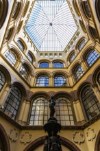 Donaunix fountain and glass dome in Palais Ferstel, Vienna, Austria