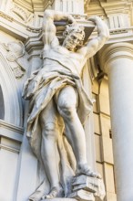 Marble statue as a support on a historic building of the Kinski auction house, Vienna, Austria