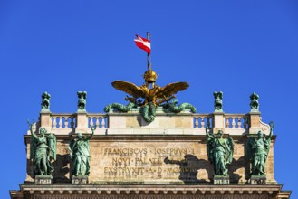 The roof with bronze statues, golden eagle and the Austrian national flag, above the main entrance