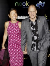 Woody Harrelson and Laura Louie at the Los Angeles premiere of 'The Hunger Games' held at the Nokia