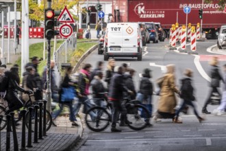 Pedestrians at Düsseldorf-Bilk train station, cross Friedrichstraße at a pedestrian crossing with
