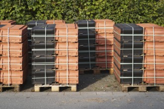 Borken, NRW, Germany, RBundled roof tiles on wooden pallets for construction or renovation