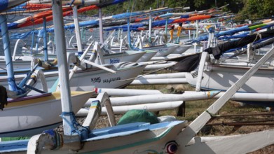 Close-up view of many local small fishing boats outrigger boats on the beach of sea bay near Amed,
