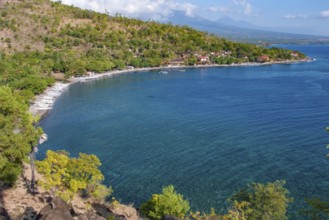 View from an elevated position of many local small fishing boats outrigger boats on the beach of