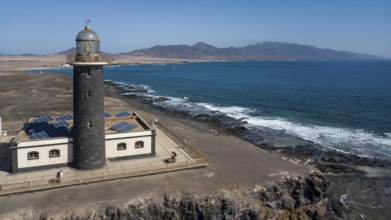 Aerial view of Faro Punta de Jandia lighthouse on a rocky outcrop at the southern tip of Jandia