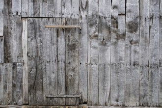 Wooden door with metal fittings in an old wooden barn, Borken-Weseke, Münsterland, North