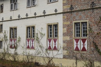 Historic façade with brick, lattice windows and red and white shops in a quiet autumn atmosphere,