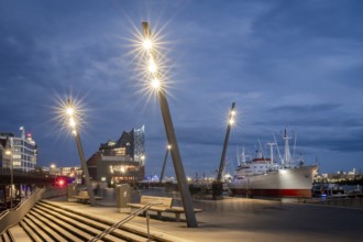 Blue hour at Hamburg Landungsbrücken with Elbe Philharmonic Hall, Cap San Diego ship and shining