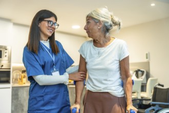 Professional caregiver in uniform supporting an elderly woman using crutches, providing assistance