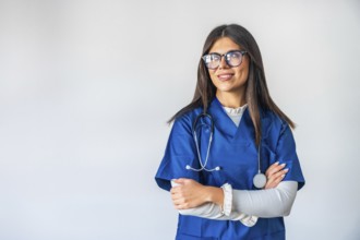 Young woman working as a professional healthcare provider, confidently standing with crossed arms,