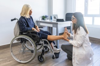 Female doctor examining an elderly woman's foot during a rehabilitation session, focusing on