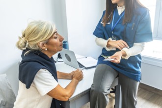 Doctor in scrubs explaining a new prescription to an attentive senior patient during a medical