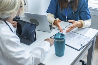 Healthcare professionals discussing medical information during a consultation in an office with a
