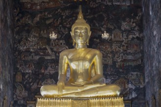 Golden Buddha statue, Phra Buddha Trilokachet surrounded by crystal chandeliers and exquisite wall