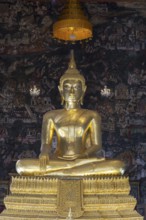 Golden Buddha statue, Phra Buddha Trilokachet surrounded by crystal chandeliers and exquisite wall