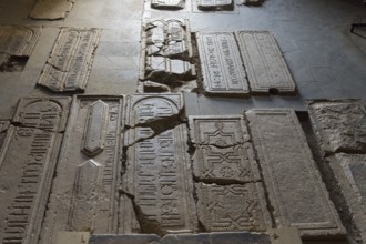 Burial slabs with ancient inscriptions and signs set in the ground, Noravank Monastery, Surb