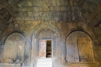 Detail of an ancient stone building with wall engravings and reliefs that conveys a historically